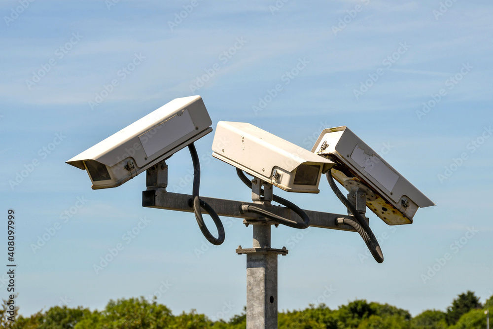 Close up view of remote controlled CCTV cameras mounted on a tall post Close up view of remote controlled CCTV cameras mounted on a tall post