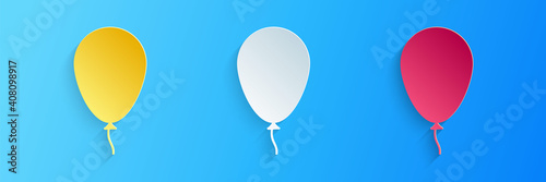 Paper cut Balloon with ribbon icon isolated on blue background. Paper art style. Vector.