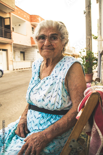 Italian Grandma in front of her house