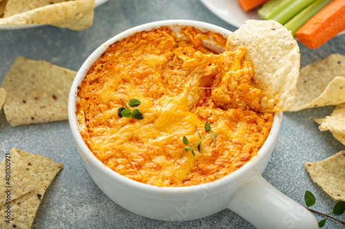 Buffalo chicken dip served with chips and fresh vegetables photo