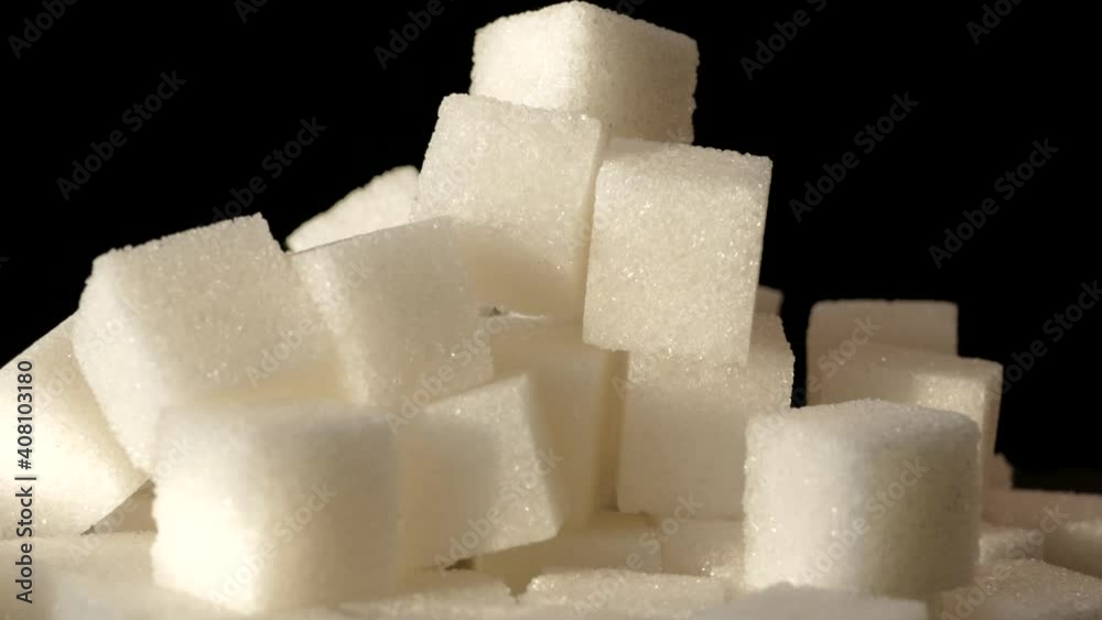 Refined sugar close-up on a black background. Sweet ingredient. Healthy eating and diabetes. Refined sugar close-up on a black background. Sweet ingredient. Healthy eating and diabetes.