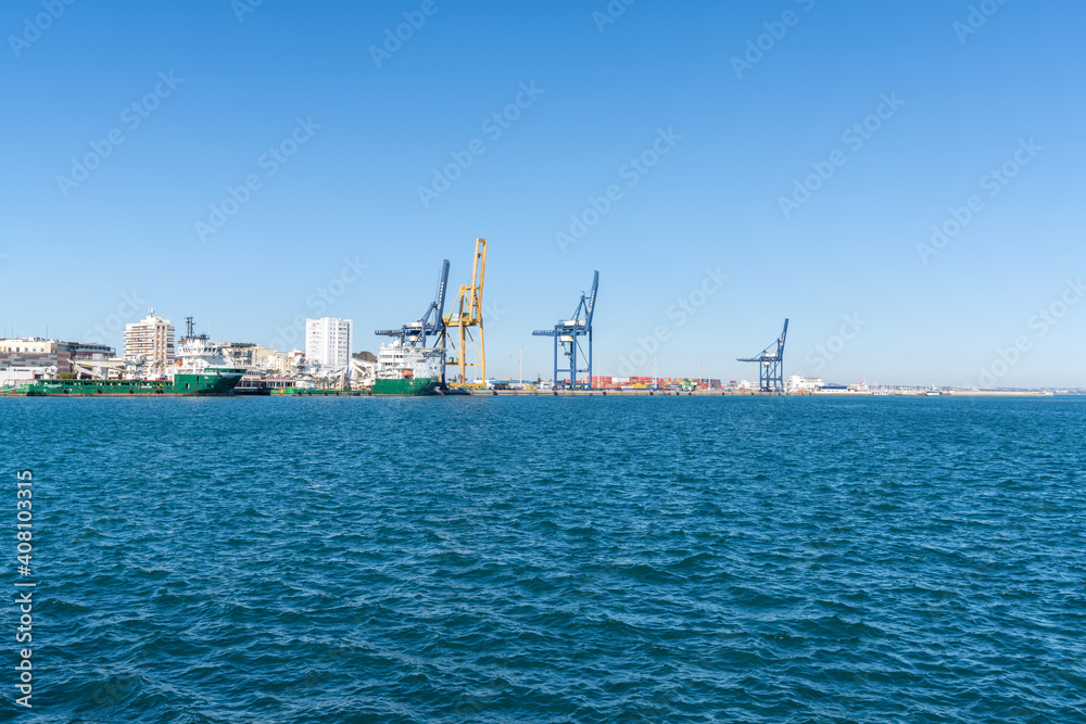 supply ships and harbor cranes in the industrial port in Cadiz