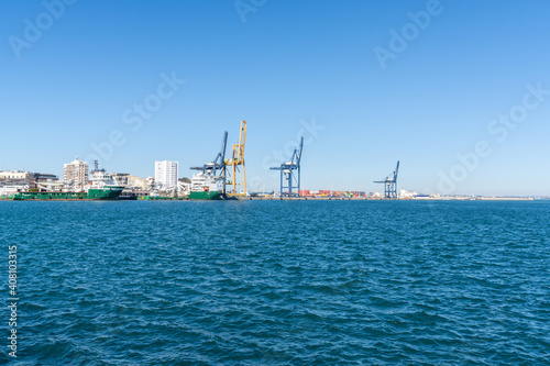 supply ships and harbor cranes in the industrial port in Cadiz