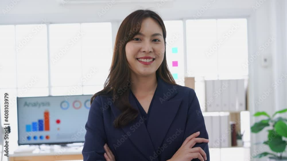 Beautiful young businesswoman portrait looking at camera in office Beautiful young businesswoman portrait looking at camera in office