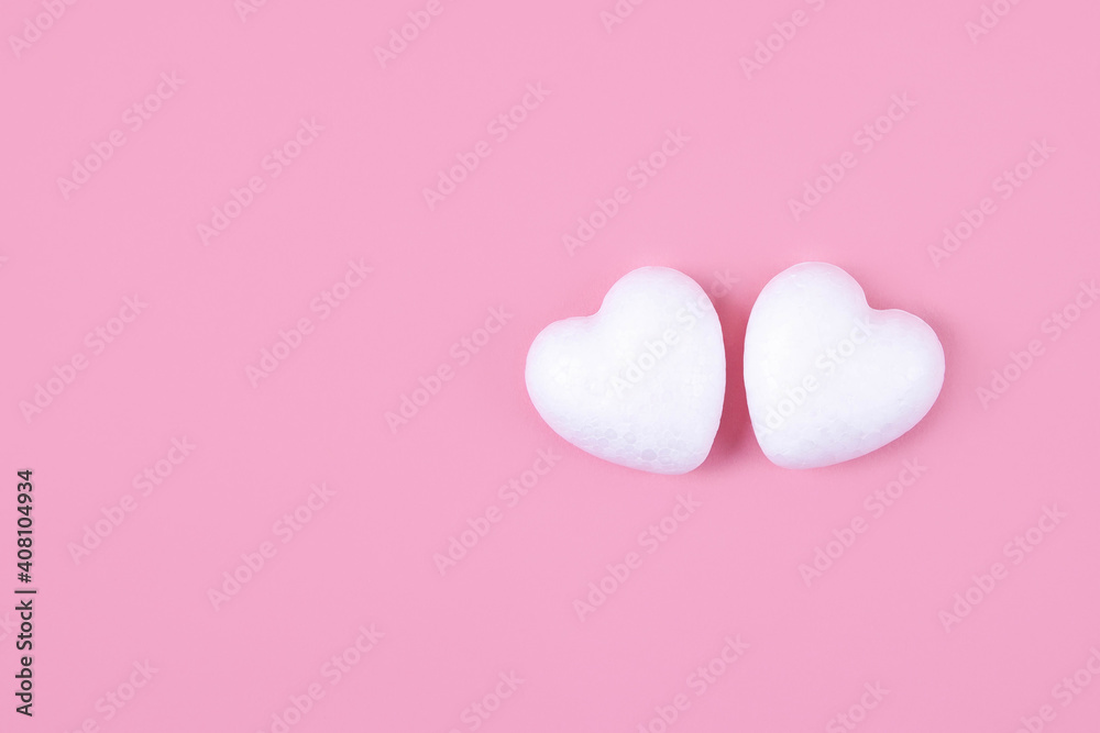 Two little white hearts on a pink background