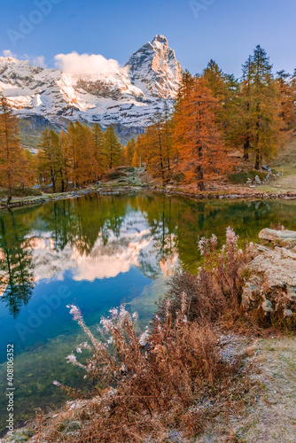 Blue Lake and the surroundings area during the fall and changing of the colors. Foliage, reflection and snowy peaks.
