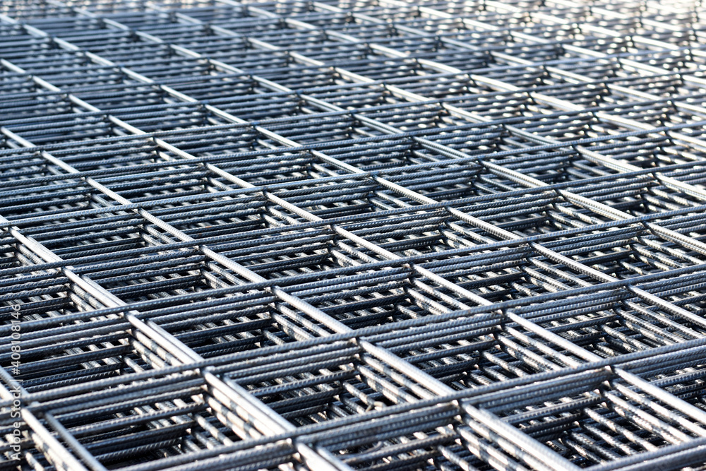 Steel bar for building materials. Wire reinforcing mesh. Industrial grunge background.