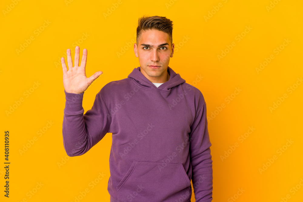 Young handsome caucasian man isolated smiling cheerful showing number five with fingers. Young handsome caucasian man isolated smiling cheerful showing number five with fingers.