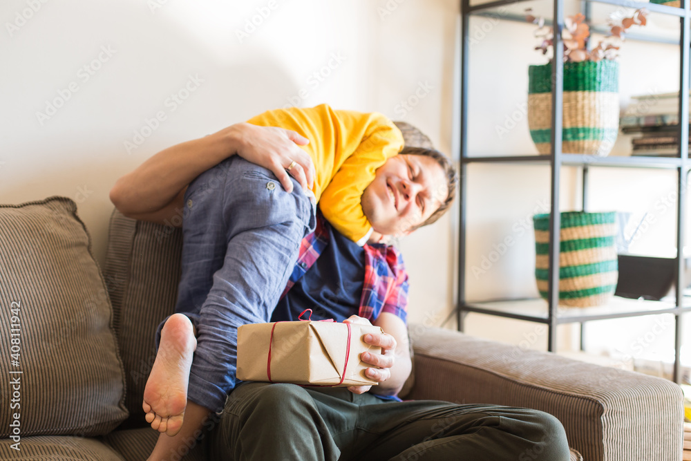 Obraz premium Father's day, happy family, boy and his dad at home