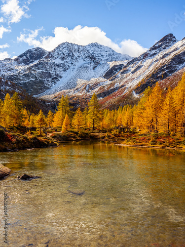Fototapeta Naklejka Na Ścianę i Meble -  Arpy Lake and the surrounding area during the fall and changing of the colors. Foliage, reflection and snowy peaks