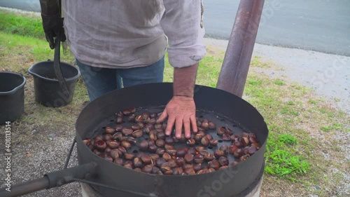 Man roast chestnuts on an open fire
