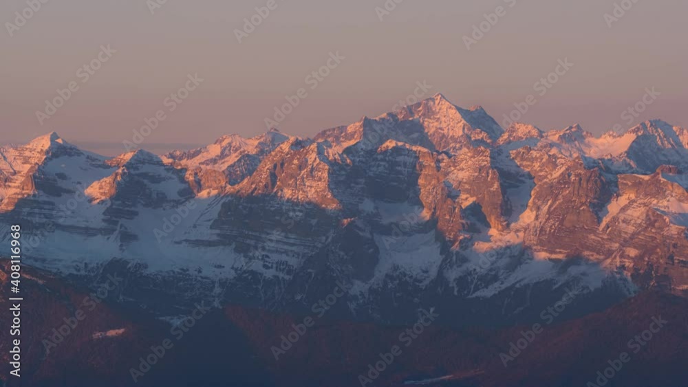 Beautiful Sunrise on Dolomiti di Brenta with snowy mountaintop and colorful sun reflection. Time lapse twilight wide shot Beautiful Sunrise on Dolomiti di Brenta with snowy mountaintop and colorful sun reflection. Time lapse twilight wide shot