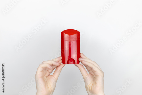 A woman is holding antiperspirant. Place for your text. The concept of hazardous substances in cosmetics and household chemicals photo