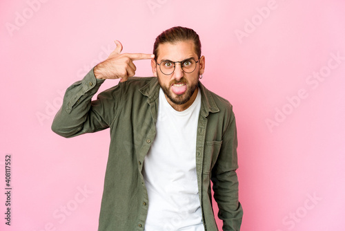Young man with long hair look showing a disappointment gesture with forefinger.
