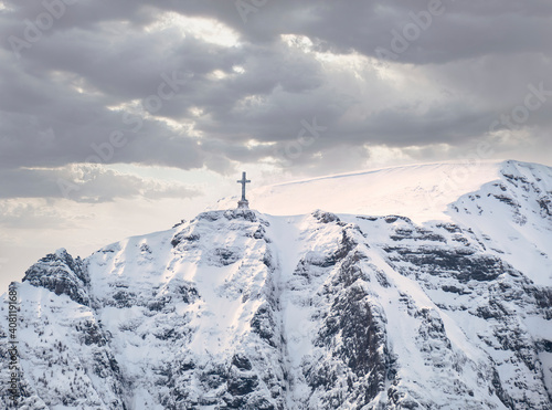 View with the Heroes Cross on Caraiman peak, in BUcegi Mountains Romania. © Cristi