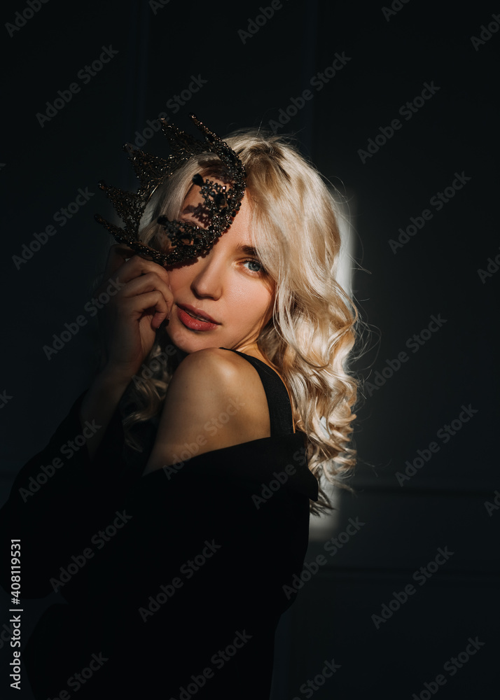 Portrait of a beautiful sensual blonde woman, wearing a crown, looking at camera.