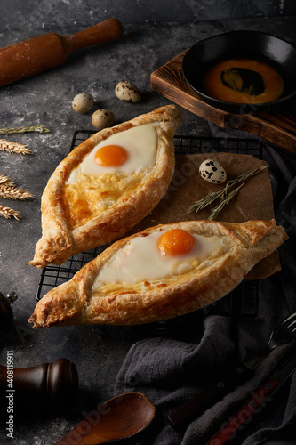 Traditional Adjarian khachapuri pies with salted cheese and egg photo