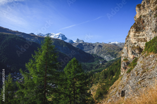 Zermatt in the swiss alps wallis with trees forest wood sunlight matterhorn view path