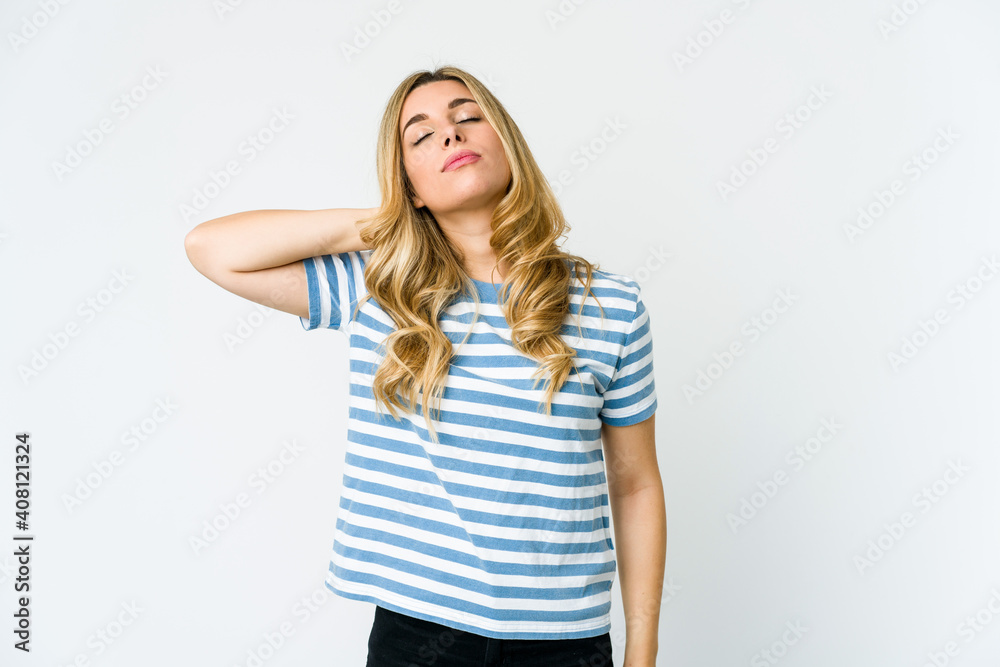 Young caucasian blonde woman having a neck pain due to stress, massaging and touching it with hand. Young caucasian blonde woman having a neck pain due to stress, massaging and touching it with hand.