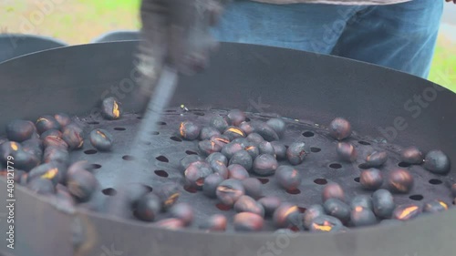 Man roast chestnuts on an open fire