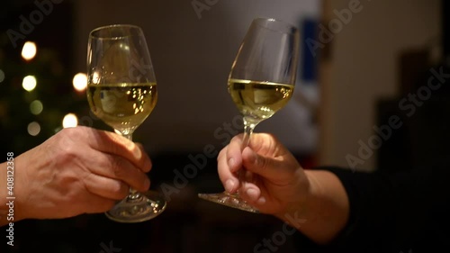 Close up of two persons clinking glasses. Close up of two persons clinking wine glasses.