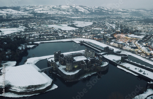 An aerial shot of Caerphilly Castle surround by snow.