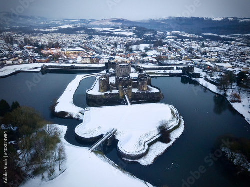 An aerial shot of Caerphilly Castle surround by snow.