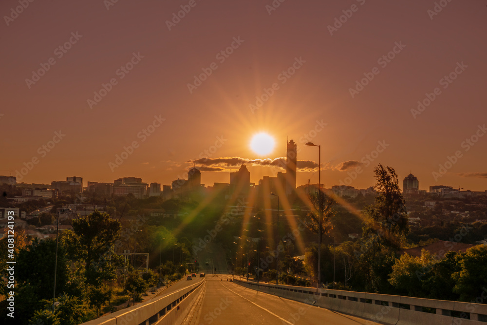 Fototapeta premium Sandton city buildings from the bridge during sunset