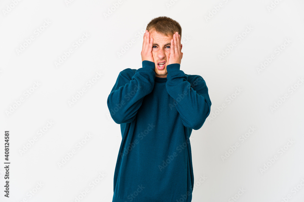 Young caucasian handsome man having fun covering half of face with palm.