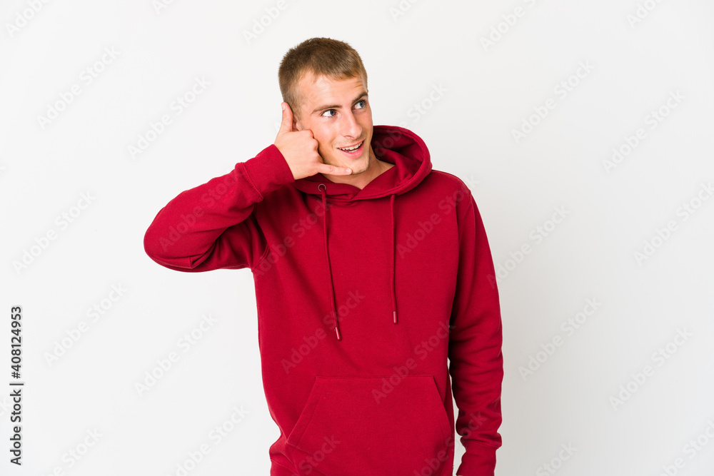 Young caucasian handsome man showing a mobile phone call gesture with fingers. Young caucasian handsome man showing a mobile phone call gesture with fingers.