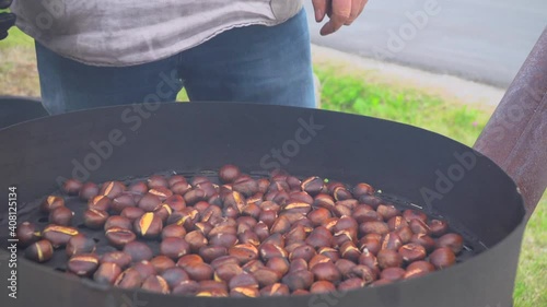 Man roast chestnuts on an open fire