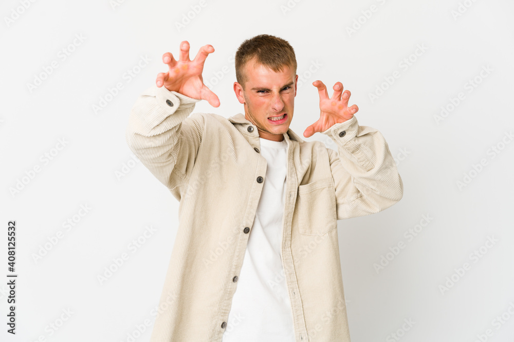 Young caucasian handsome man showing claws imitating a cat, aggressive gesture. Young caucasian handsome man showing claws imitating a cat, aggressive gesture.