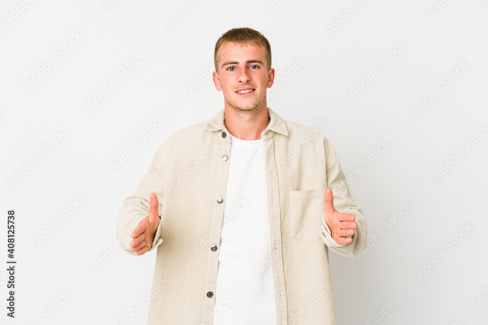 Young caucasian handsome man holding something with both hands, product presentation. Young caucasian handsome man holding something with both hands, product presentation.