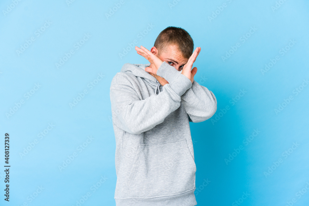 Young caucasian handsome man keeping two arms crossed, denial concept. Young caucasian handsome man keeping two arms crossed, denial concept.
