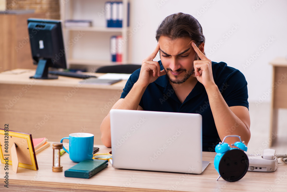 Young male employee working at workplace Young male employee working at workplace