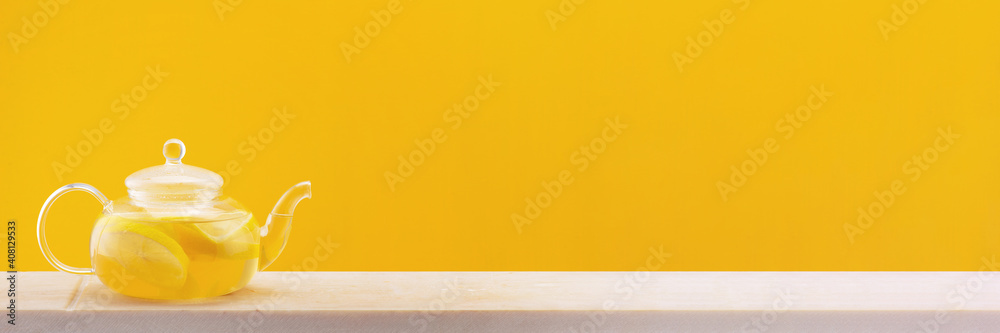Yellow banner with teapot with hot vitamin lemon beverage Yellow banner with teapot with hot vitamin lemon beverage