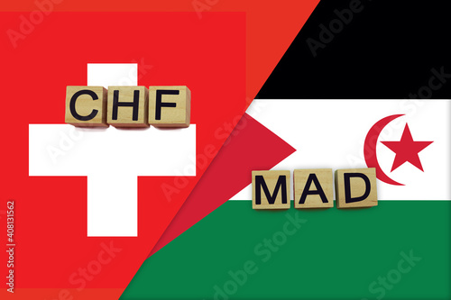 Switzerland and Western Sahara currencies codes on national flags background