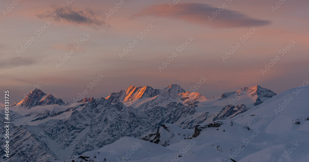 beautiful sunrise in the Swiss alps on a winter day surrounded by snow and mountains in the idyllic place Melchsee-Frutt, Switzerland