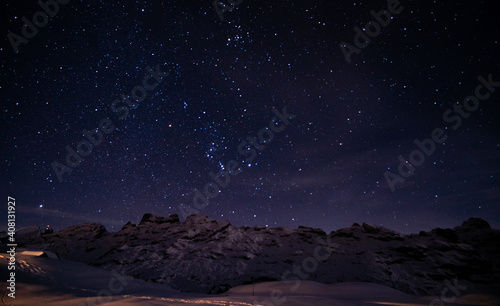 amazing winter night in the Swiss alps. bright stars  mountains and snow in Melchsee-Frutt  Switzerland