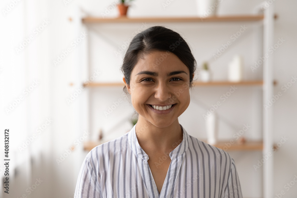 Headshot portrait of pretty smiling millennial female of indian ethnicity housewife student employee in casual closing. Profile picture of happy young mixed race lady looking at camera posing at home Headshot portrait of pretty smiling millennial female of indian ethnicity housewife student employee in casual closing. Profile picture of happy young mixed race lady looking at camera posing at home