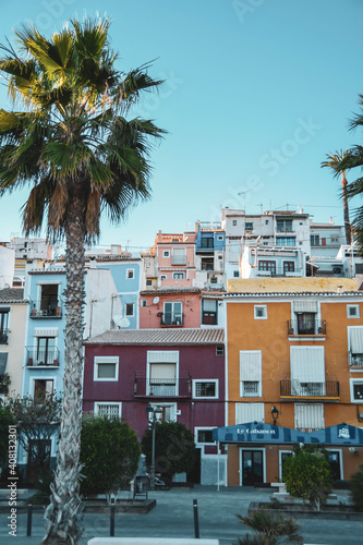Fototapeta Naklejka Na Ścianę i Meble -  Coloured Houses (Cases de Colors) on the sandy beach in Villajoyosa in Costa Blanca with palms near Benidorm