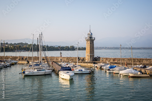Lighthouse on the mole of the Bay of Desenzano del Garda. A clear, autumn evening. Lombardy, Italy