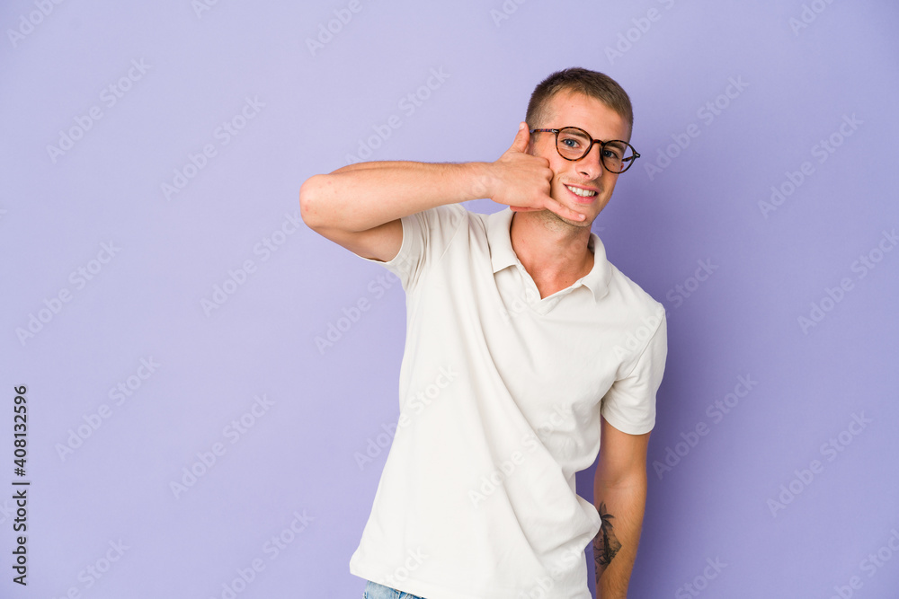 Young caucasian handsome man showing a mobile phone call gesture with fingers. Young caucasian handsome man showing a mobile phone call gesture with fingers.