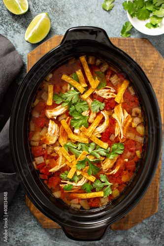 Slow cooker chicken taco soup topped with fresh cilantro