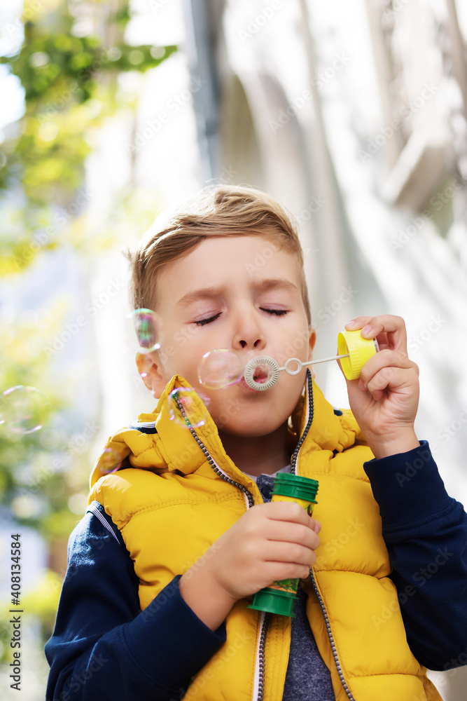 Little boy blowing soap bubbles outdoors, Little boy blowing soap bubbles outdoors,