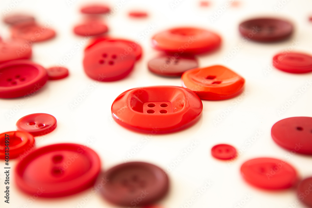 group of red buttons of different sizes on white background group of red buttons of different sizes on white background