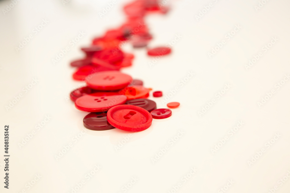 group of red buttons of different sizes on white background group of red buttons of different sizes on white background