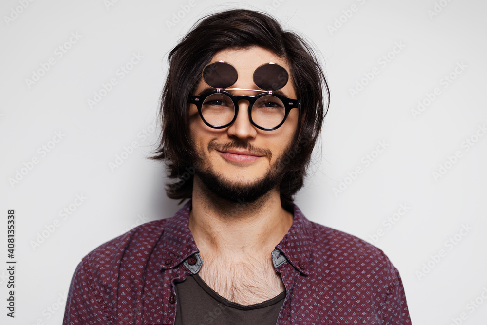 Studio portrait of young smiling guy with round sunglasses on white background. Studio portrait of young smiling guy with round sunglasses on white background.