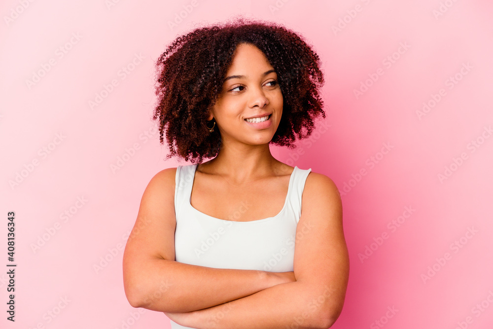 Young african american mixed race woman isolated smiling confident with crossed arms.
