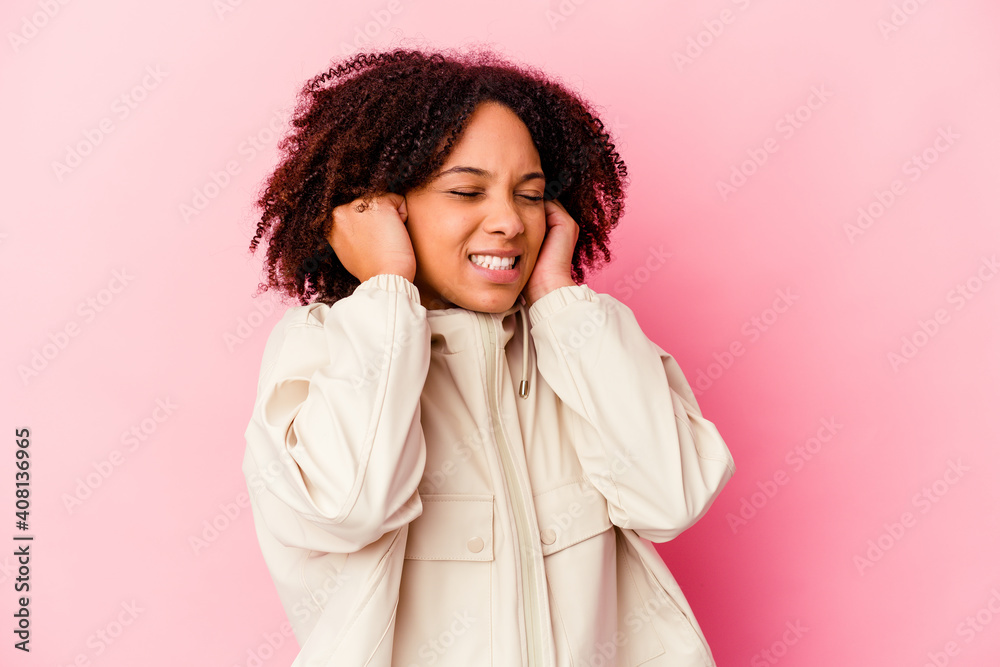 Young african american mixed race woman isolated covering ears with hands.